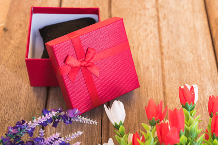 Red heart, flower and gift box on wooden background with copy space, valentine day conceptの写真素材
