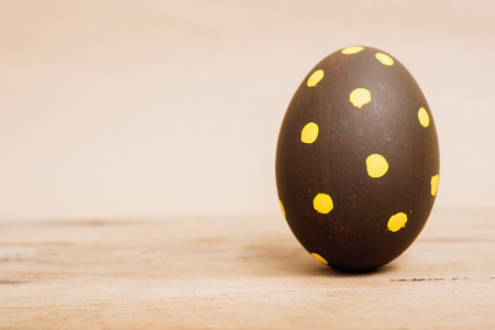 Beautiful Easter Brown egg on wooden background, Easter day conceptの写真素材