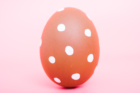 Beautiful Easter Brown egg color on pink background, Easter day conceptの写真素材