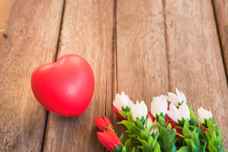 Red heart and flower on wooden background with copy space, valentine day conceptの写真素材