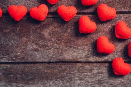 Fabric red heart on wooden background, valentine day conceptの写真素材