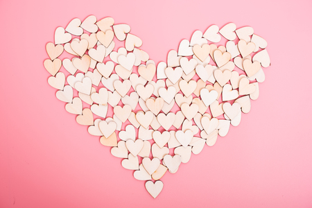 Wood hearts on pink background, valentine day conceptの写真素材