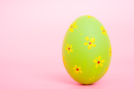 Beautiful Easter green egg color on pink background, Easter day conceptの写真素材