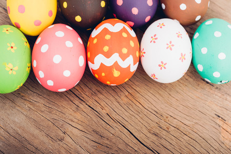 Beautiful Easter multi color egg on wooden background, Easter day conceptの写真素材
