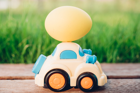 Easter egg and Car on garden grass background, Happy easter day conceptの写真素材