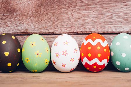 Beautiful Easter multi color egg on wooden background, Easter day conceptの写真素材