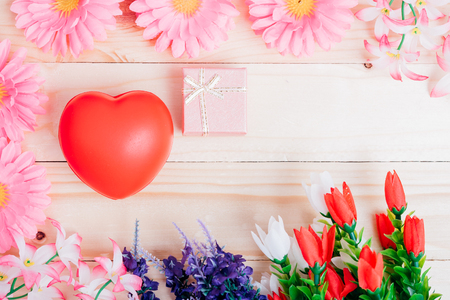 Red heart, flower and gift box on wooden background with copy space, valentine day conceptの写真素材