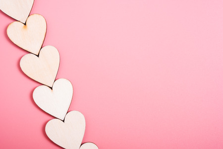 Wood hearts on pink background have copy space, valentine day conceptの写真素材