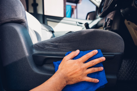 Worker man cleaning dust interior by cloth microfiber inside car after washの写真素材