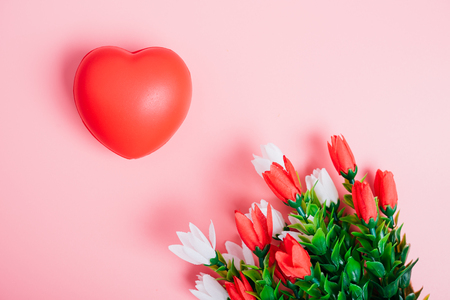 Red heart and flower on pink background with copy space, valentine day conceptの写真素材