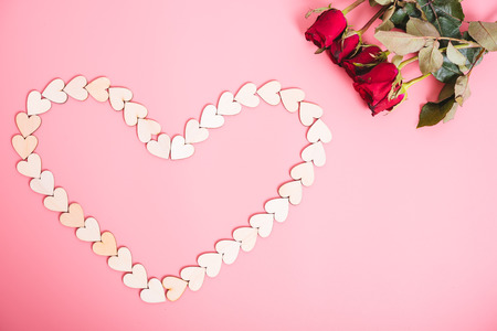 Wood hearts on pink background have a flower rose, valentine day conceptの写真素材