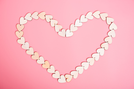 Wood hearts on pink background, valentine day conceptの写真素材