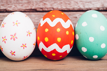 Beautiful Easter multi color egg on wooden background, Easter day conceptの写真素材