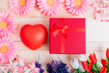 Red heart, flower and gift box on wooden background with copy space, valentine day conceptの写真素材
