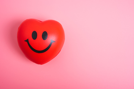 Red heart on pink background with copy space, valentine day conceptの写真素材