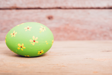 Beautiful Easter Green egg on wooden background, Easter day conceptの写真素材