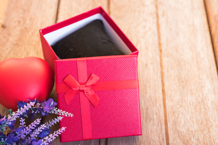 Red heart, flower and gift box on wooden background with copy space, valentine day conceptの写真素材