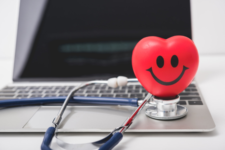 Health stethoscope and red heart on keyboard of laptop computer, medical conceptの写真素材
