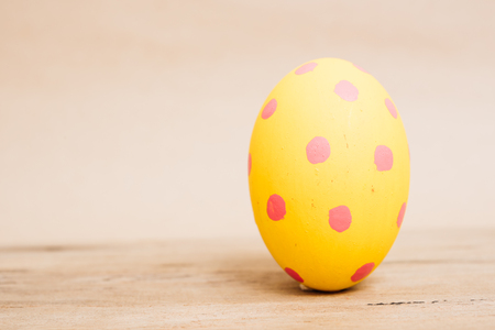 Beautiful Easter Yellow egg on wooden background, Easter day conceptの写真素材