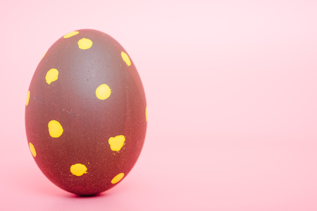 Beautiful Easter Brown egg color on pink background, Easter day conceptの写真素材