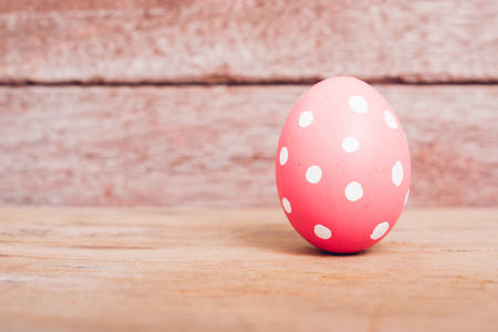 Beautiful Easter Pink egg on wooden background, Easter day conceptの写真素材