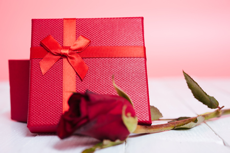 Gift box and flower roses on white wooden background, valentine day conceptの写真素材