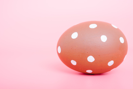 Beautiful Easter Brown egg color on pink background, Easter day conceptの写真素材