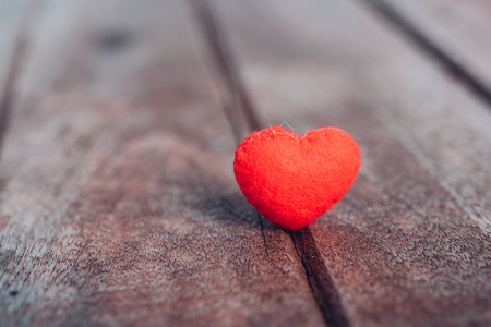 Red heart stand on wooden background, valentine day conceptの写真素材