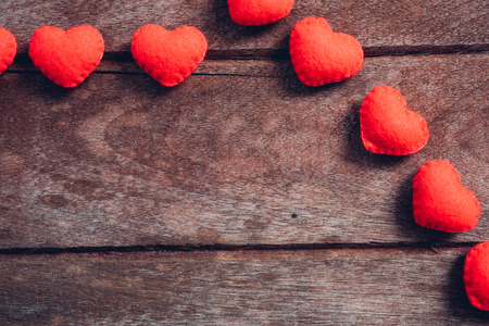 Fabric red heart on wooden background, valentine day conceptの写真素材