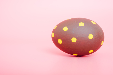 Beautiful Easter Brown egg color on pink background, Easter day conceptの写真素材