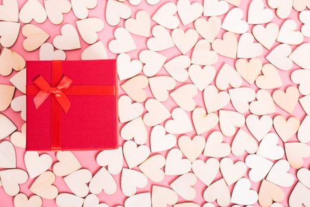 Wood hearts on pink background have a gift box, valentine day conceptの写真素材