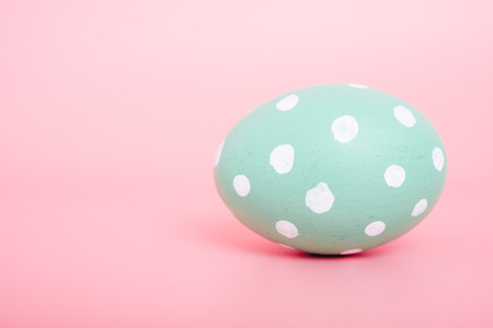 Beautiful Easter Green egg color on pink background, Easter day conceptの写真素材