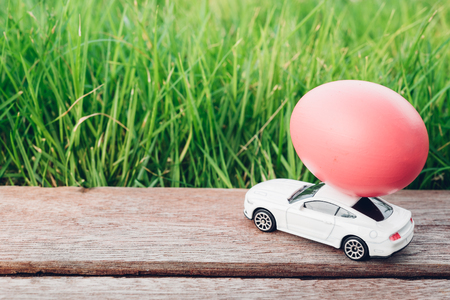 Easter egg and Car on garden grass background, Happy easter day conceptの写真素材