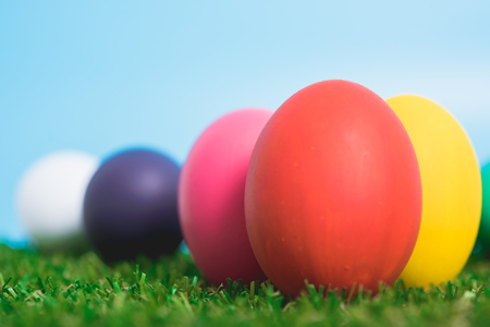Blue Easter eggs clean on grass and pink background, easter day conceptの写真素材