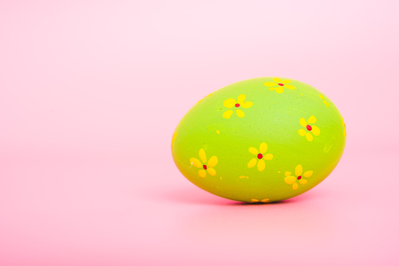 Beautiful Easter green egg color on pink background, Easter day conceptの写真素材