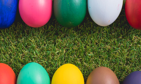 Easter eggs clean frame on green grass background, easter day conceptの写真素材