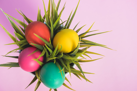Top view of Easter eggs clean in grass on pink background, easter day conceptの写真素材