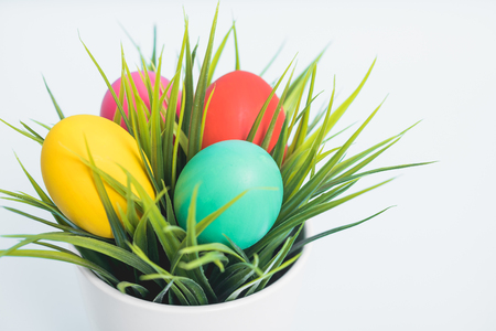 Top view of Easter eggs clean in grass on white wooden background, easter day conceptの写真素材