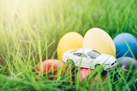 Easter egg and Car on grass background, happy easter day conceptの写真素材