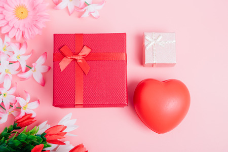 Red heart, flower and gift box on pink background with copy space, valentine day conceptの写真素材
