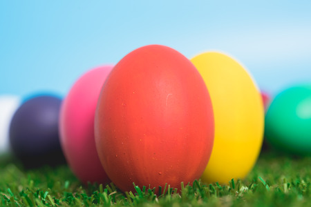 Blue Easter eggs clean on grass and pink background, easter day conceptの写真素材