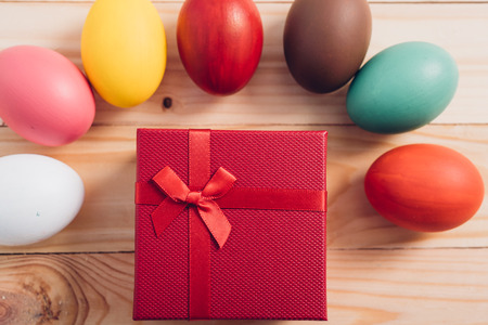 Easter eggs clean around red box gift on wooden background, easter day conceptの写真素材