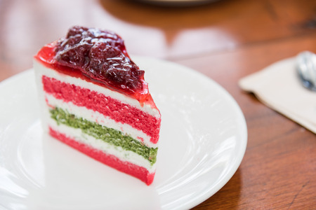 Sliced tasty strawberry cake on wooden table backgroundの写真素材