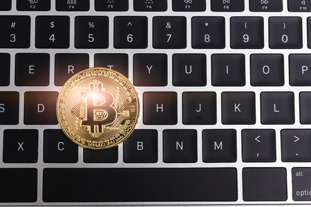 Coin, virtual digital golden bitcoin money business on keyboard laptop computer, electronic finance conceptの写真素材