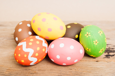 Beautiful Easter multi color egg on wooden background, Easter day conceptの写真素材