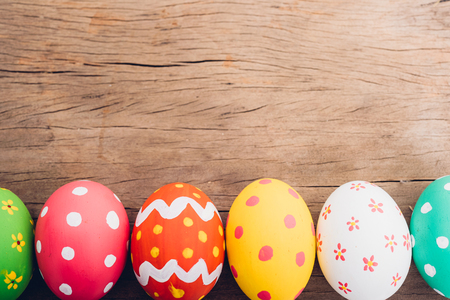 Beautiful Easter multi color egg on wooden background, Easter day conceptの写真素材