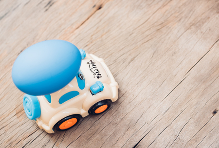 Easter egg and toy car on wooden background, happy easter day conceptの写真素材