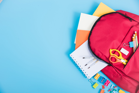 Top view Red bag backpack for education children on blue background back to school concept