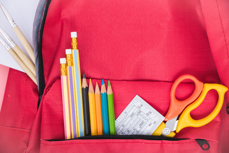 Top view Red bag backpack for education children on pink background back to school concept