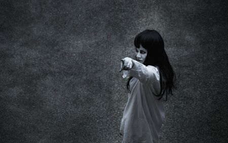 Woman ghost horror under building house point finger to your face, halloween conceptの写真素材